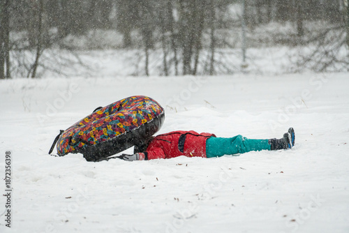 Fényképezés Child Fallen in Snow After Sledding Accident in Winter Park, Funny Outdoor Play