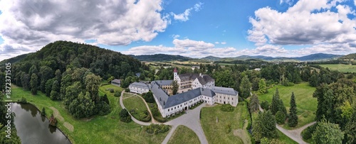 Aerial view of the town of Velké Losiny in the foothills of the Jeseníky Mountains. Drone view of Velké Losiny Castle and the castle garden.