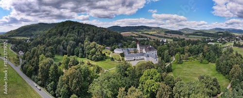 Aerial view of the town of Velké Losiny in the foothills of the Jeseníky Mountains. Drone view of Velké Losiny Castle and the castle garden.