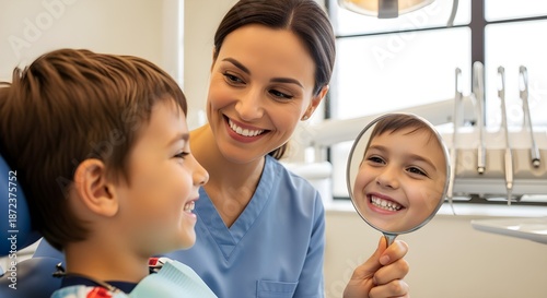 A kind dentist showing a young child their reflection with a big, shiny smile after a cleaning, both wearing smiles.