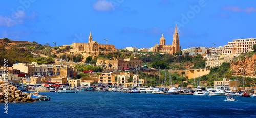 Church of Holy Mother Lurdskaya .This beautiful church, built in the traditional yellow-white Gozo stone, overlooks Mgarr Harbour Gozo Malta