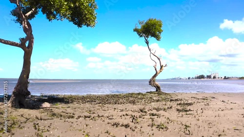 Aerial view of the coastline with the city skyline in the background, the water reflects the sky in the horizon, Maputo, Mozambique.