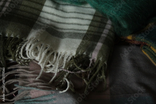 pile of colorful plaid scarves with fringe