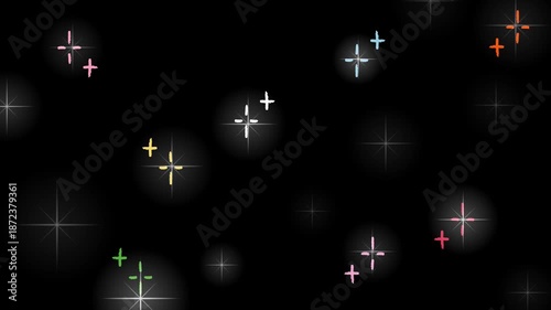 Animated colorful glowing star sparkles float on dark background with soft light flares, creating an abstract night sky fantasy atmosphere