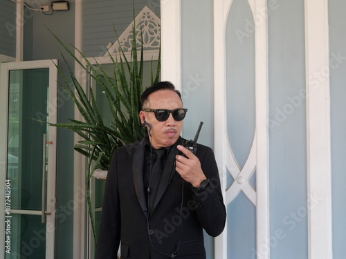 Professional bodyguard protecting VIP businessman with security awareness