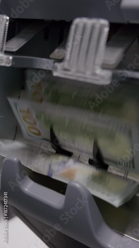 High-Speed Money Counter Counting Ten Thousand Dollars in 100 USD Banknotes