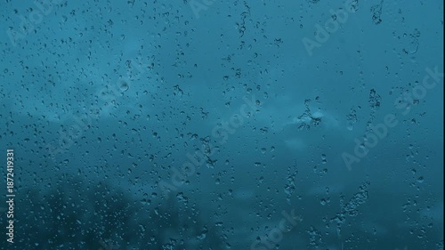 Snow melts on the window glass. Winter. Night. Thaw.
Fast moving clouds outside the window