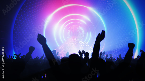 Obraz na plátne Concert crowd with raised hands enjoying the music and vibrant light show