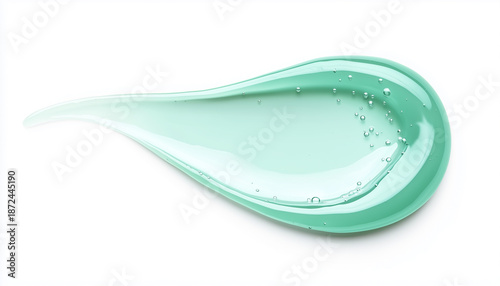 Clear light green cosmetic gel smear on white background. Liquid substance forms flowing texture. Isolated macro view