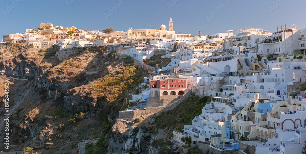 Obraz premium White cliffside buildings and churches in Fira, Santorini, Greece