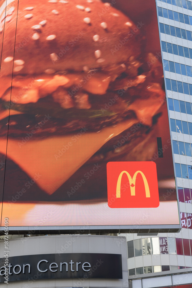 Naklejka premium ad for McDonald's Canada on electronic billboard over entrance to CF Toronto Eaton Centre facing Sankofa Square, Toronto