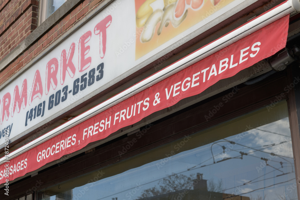 Fototapeta premium close-up detail of sign outside Dundas Street Supermarket once located at 878 Dundas St W, Toronto