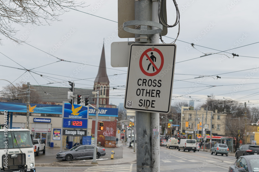 Obraz premium looking east on Dundas St W from College St road sign and defocused Ultramar - Gas Station, Toronto
