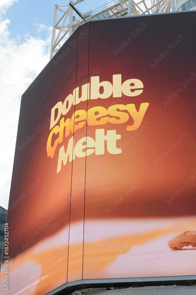 Obraz premium digital billboard featuring Double Cheesy Melt, a limited‑time burger item on the McDonald’s Canada menu in 2026 at Sankofa Square, Toronto