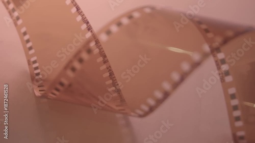  35mm negative photographic film in rotation .Slightly rolled film strip Analog film strips. Analog photography.Nostalgic memory Close-up. 