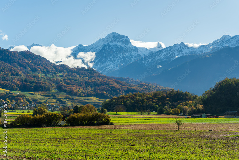 Obraz premium St-Triphon outskirts autumn fields and snowy mountains in Rhone Valley. Saint-Triphon, Canton of Vaud, Switzerland.