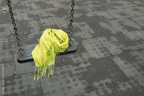 Εκτύπωση καμβά Light green scarf draped on a playground swing seat