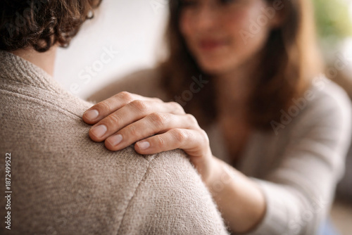 Hand on shoulder offering gentle support