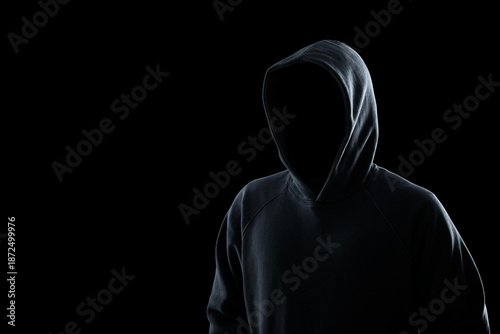 Quadro su tela Anonymous man in hood on black background. Criminal concept