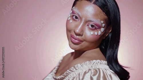 Woman with pearl embellished makeup and soft pink tones