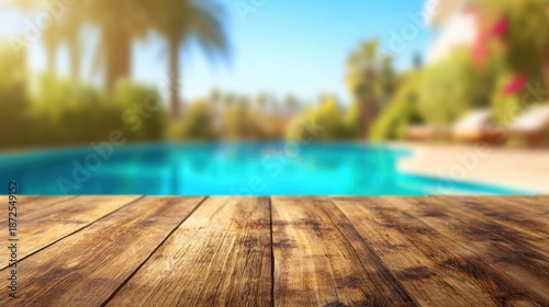 Wooden table in front of a swimming pool with palm trees in the background