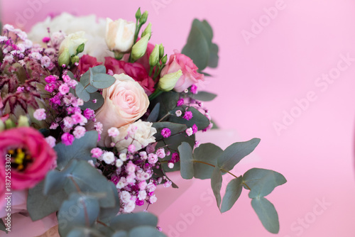 Close-up of a beautiful bouquet of flowers against a pink background