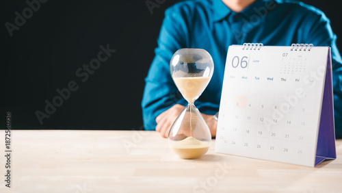 Fotografi Time running hourglass glass shows countdown for job hunting deadline, calendar
