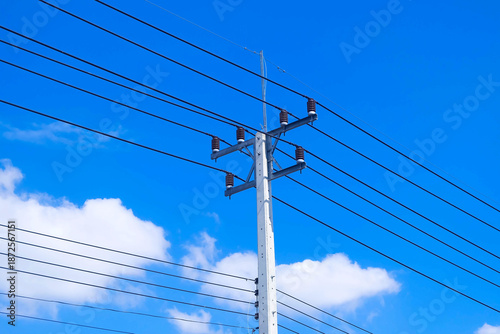 high voltage power lines against blue sky