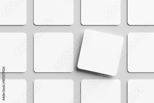 Blank white square business card mockup, placed on a gray background. Flat lay, top view, open composition.