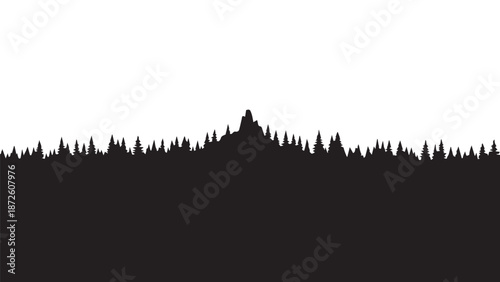 Silhouette of a dense forest and mountain ridge against a white sky at dusk.