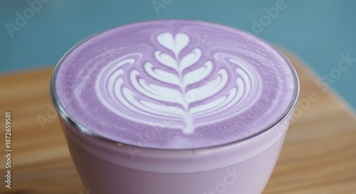 Purple Latte with Intricate Foam Art on Wooden Table