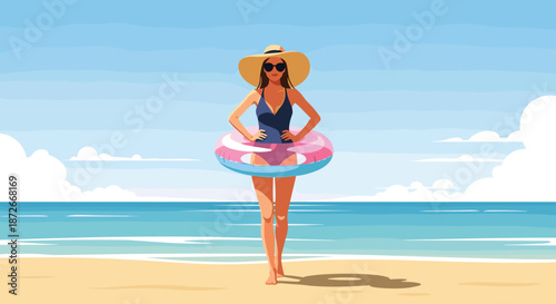 Beautiful young woman in a stylish swimsuit and sun hat posing on a sunny beach with a colorful inflatable ring.