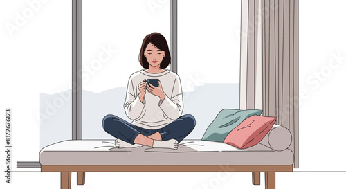 Woman sitting on a minimalist bed using a smartphone in a serene environment.