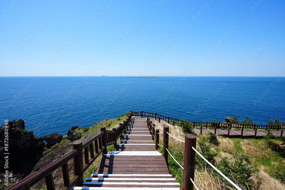 Fototapeta premium fine walkway at seaside cliff and far islands