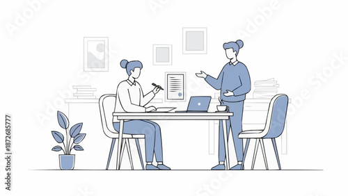 Two women collaborating in an office setting discussing work.