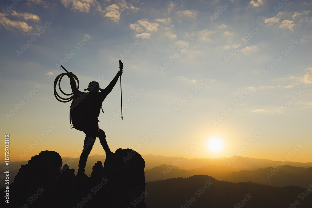 Fototapeta premium Mountain Man with backpack hiking in the mountains at sunset. spectacular success story, struggle, perseverance and ambition.