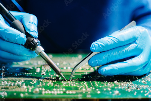 Fotografi Close up of technician soldering and repairing circuit board in a modern laboratory, electronics repair, engineering, technology, maintenance and quality control concept
