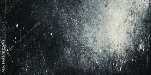 An abstract dark textured background featuring scratches dust and light leaks creating a vintage effect