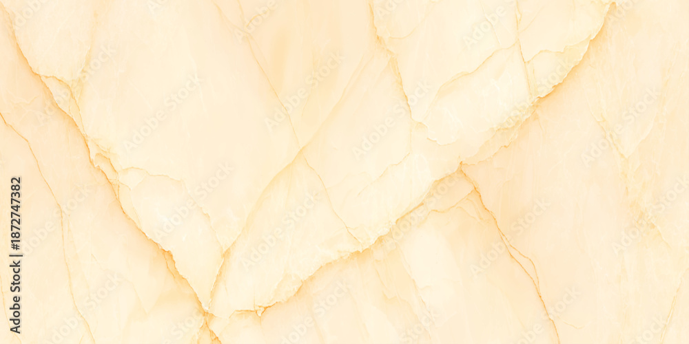 Fototapeta premium A close up view of a creamy pale yellow marble texture with natural veining patterns is displayed