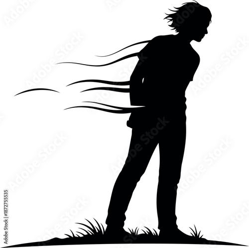 Silhouette of a person standing in the wind with flowing hair and clothes