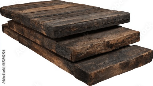 Stack of weathered, dark brown timber planks arranged in descending steps