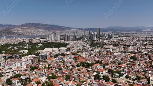 Aerial view of Izmir city skyline with modern skyscrapers, residential districts and urban landscape. Large metropolitan area with business center and mountains in background, Izmir, Turkey.