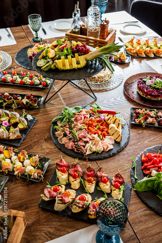 фотографія Colorful assortment of appetizers and gourmet delicacies displayed at a joyful c