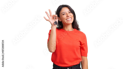 Woman holding new house keys and making OK gesture