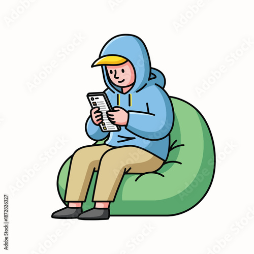 Relaxed young man in blue hoodie enjoying leisure time on a green bean bag chair with a tablet