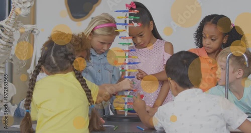 Animation of yellow spots over diverse school children in classroom