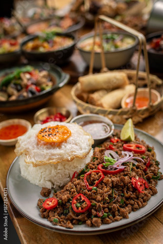 Fotografía Pad Kra Pao Pork and Holy Basil Stir fry traditional thai food meal on table at