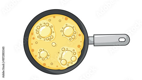 Overhead view of a frying pan actively cooking golden, bubbly batter, illustrating breakfast preparation
