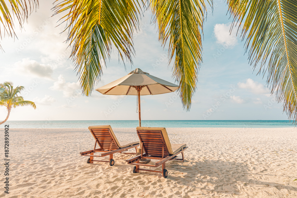Obraz premium Romantic honeymoon beach scene with love couple resting on sun beds under umbrella tropical island ocean view serene summer vacation luxury resort travel background