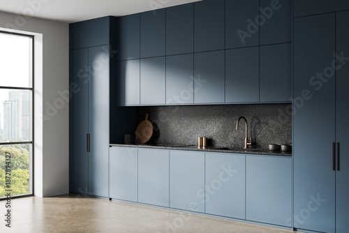 Foto Sleek modern kitchen interior with matte blue cabinetry and minimalist design aesthetic featuring a terrazzo backsplash and brass faucet accent